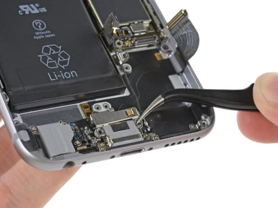 iPhone charging port repair cost — technician cleaning a Lightning port in Bangalore